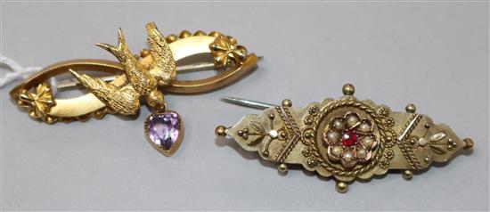 A late Victorian 9ct gold swallow brooch with heart shaped amethyst drop and an Edwardian 9ct gold and gem set brooch, largest 42mm.
